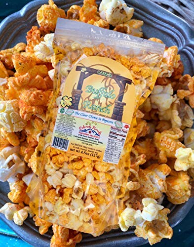 Bag of buffalo ranch popcorn on a plate with mixed popcorn.